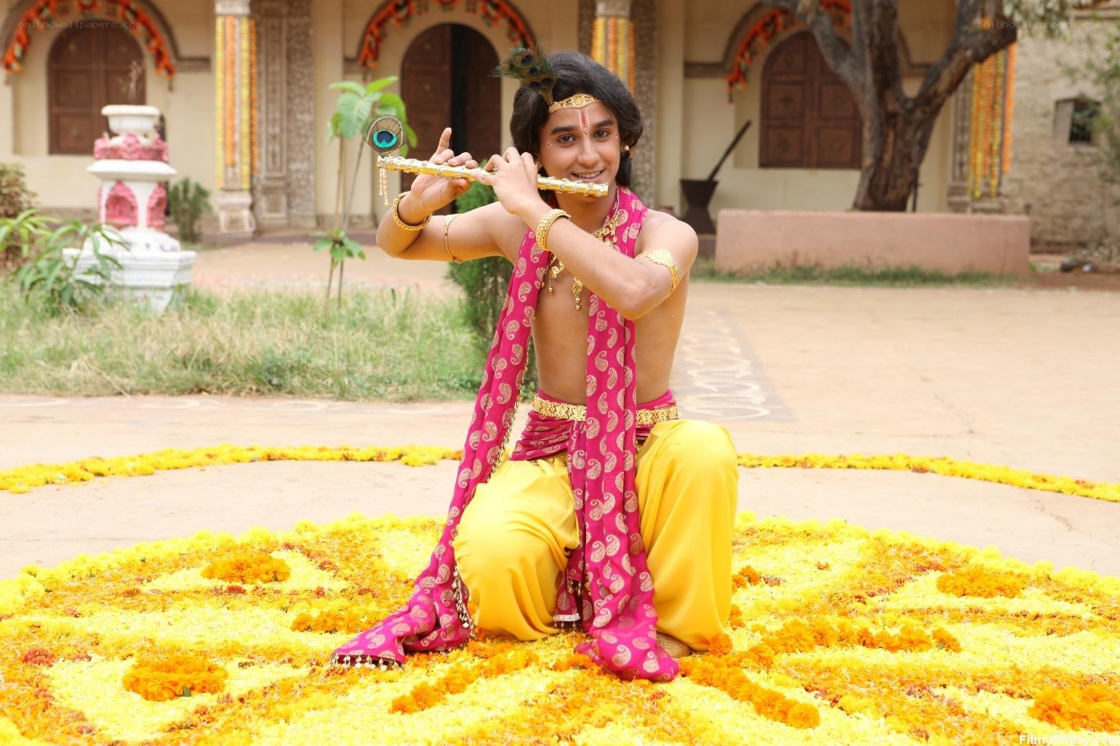 Krishna playing flute on flower petals