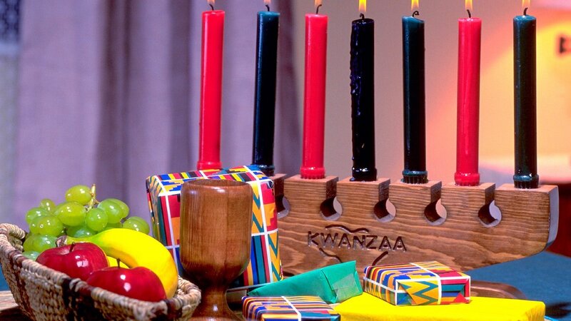 Kwanzaa celebration with candles and gifts