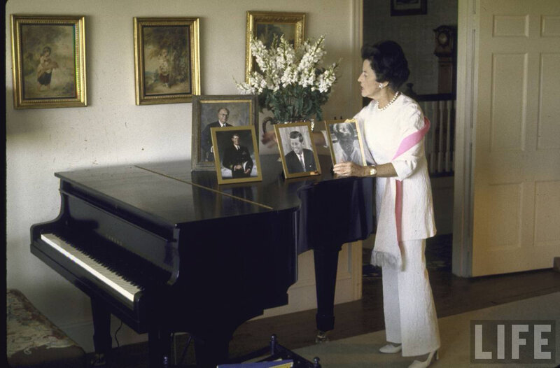 Lady with photos by piano