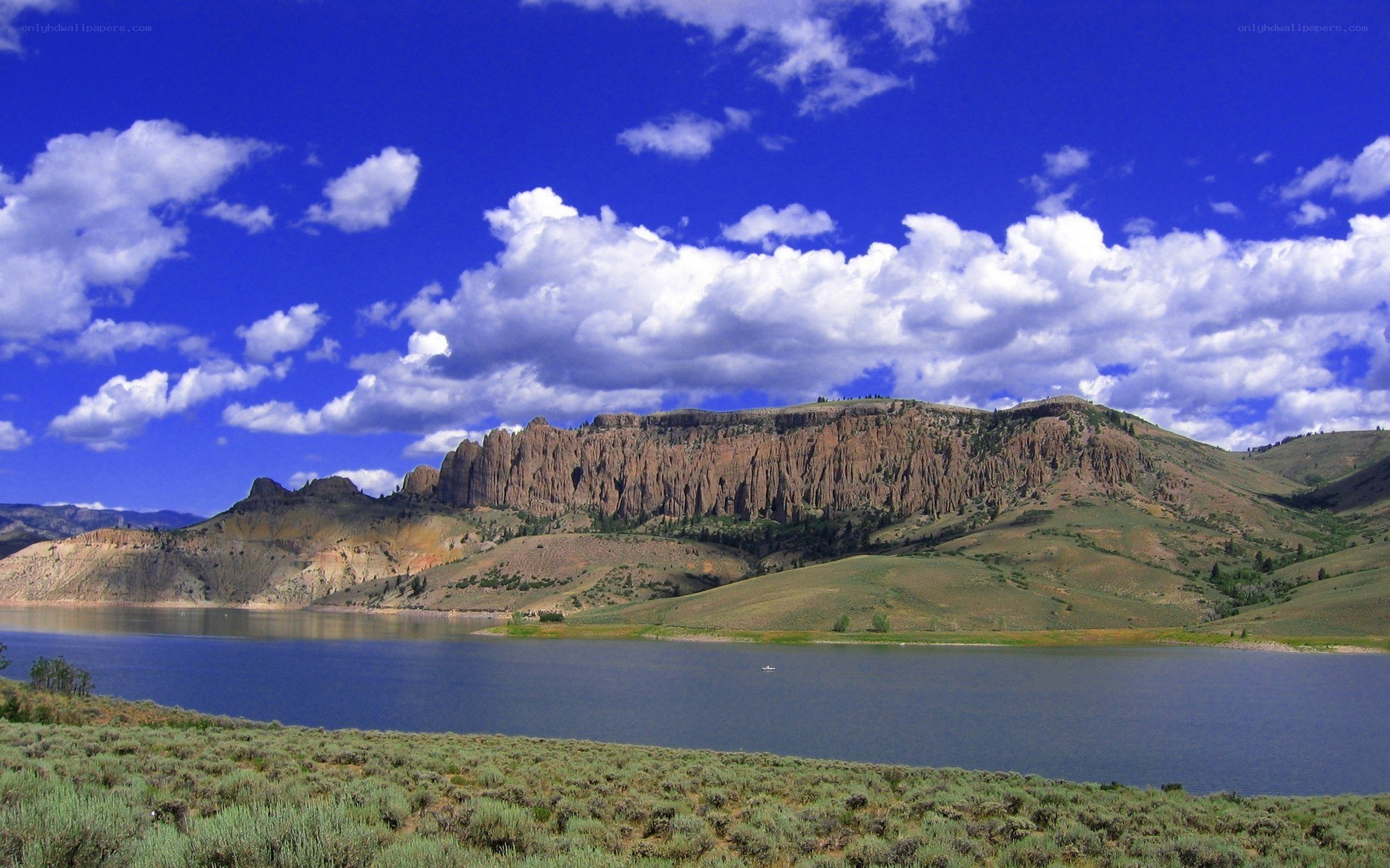 Lake and cliffs under blue sky