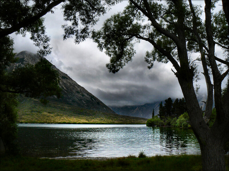 Lake and mountain under cloudy sky