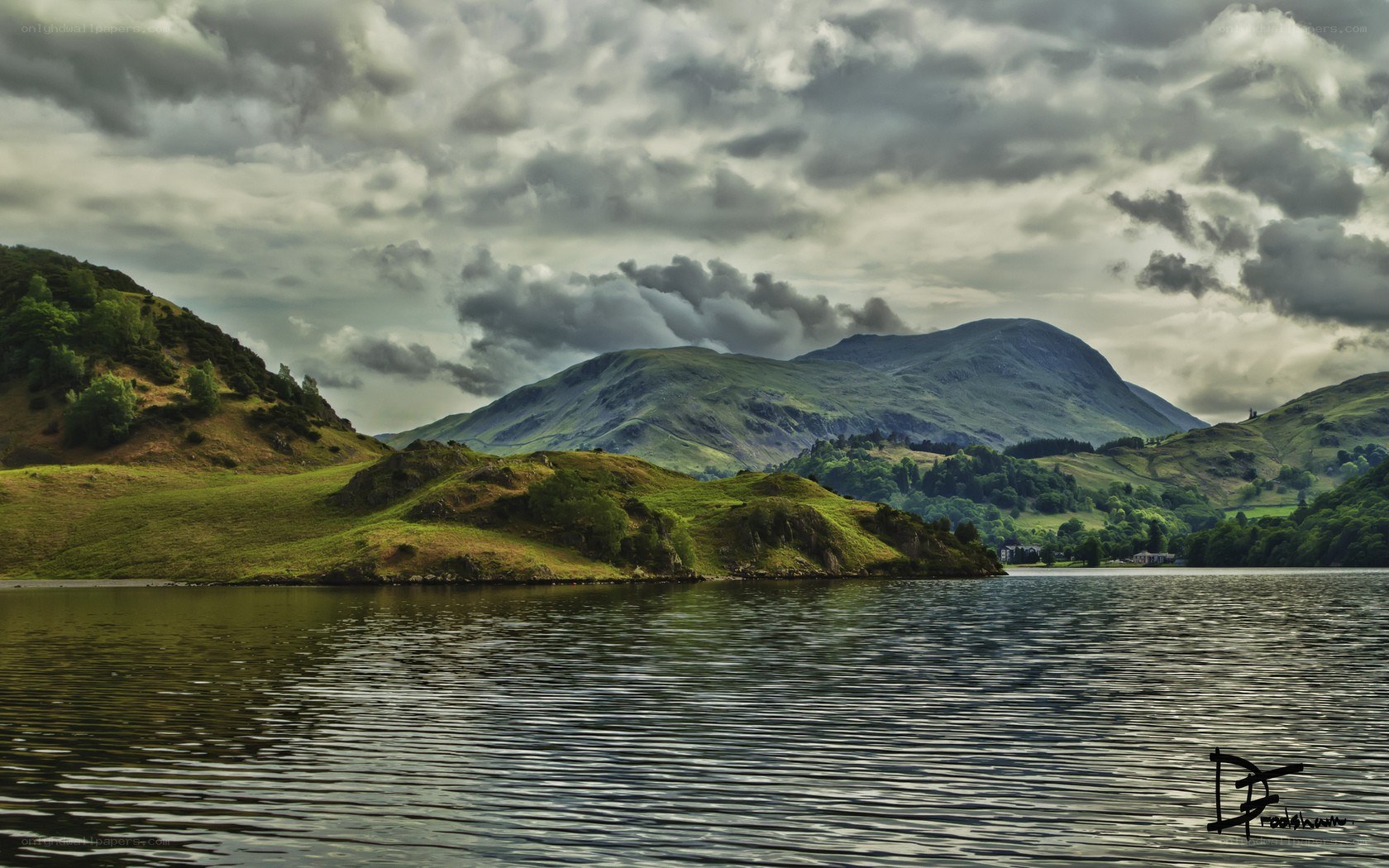 Lake and mountains under cloudy sky