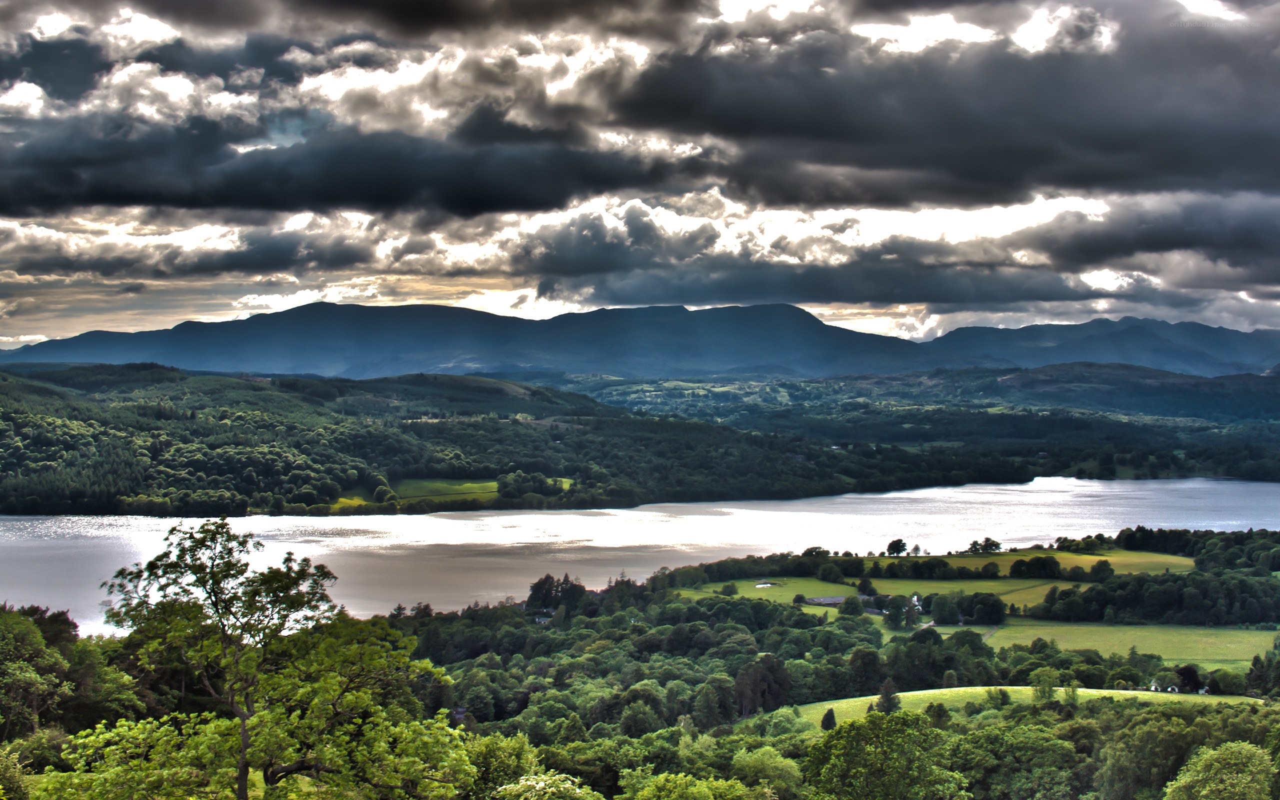 Lake and mountains under cloudy sky