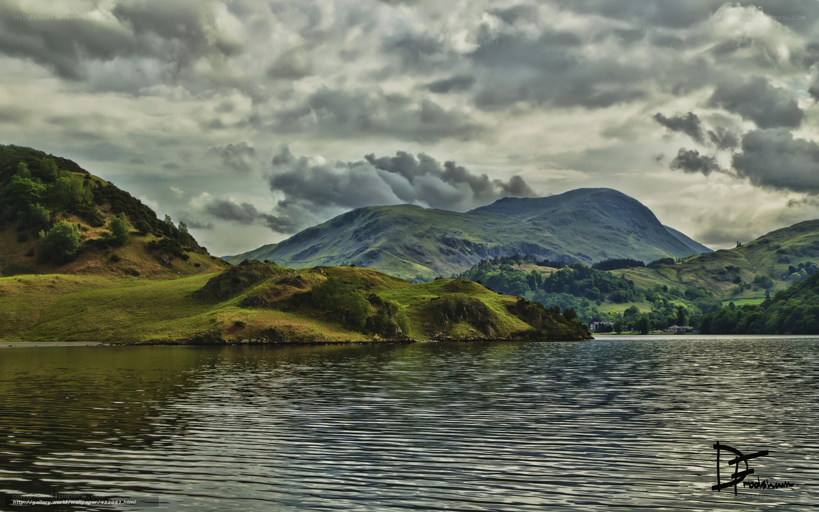 Lake and mountains under cloudy sky