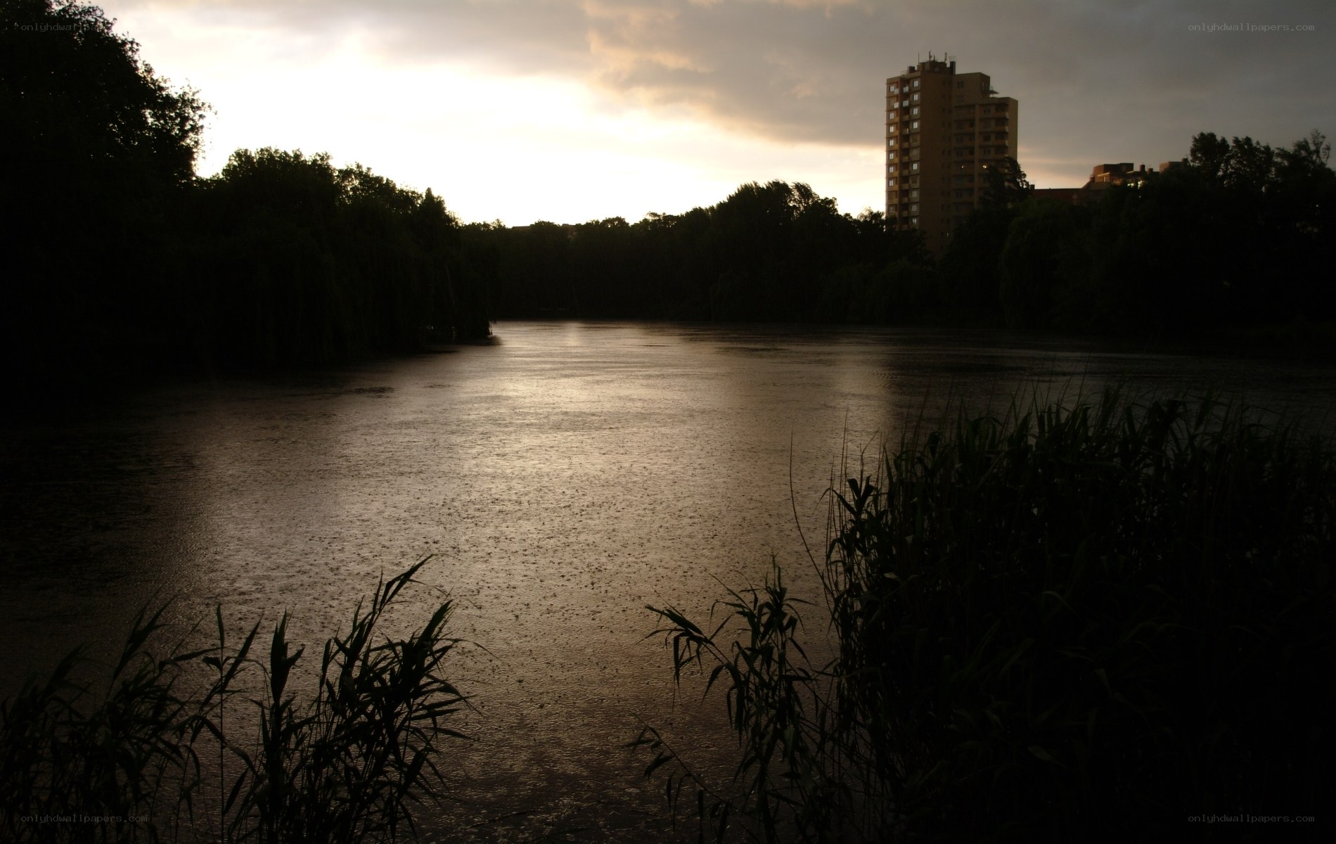 Lake at dusk with building