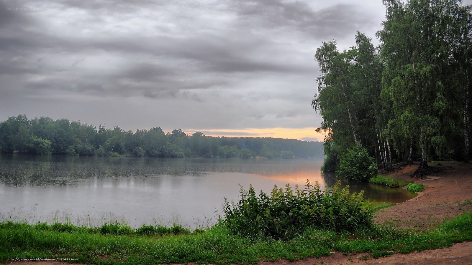 Lake at dusk with cloudy sky