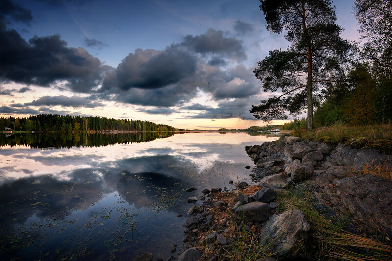 Lake at dusk with cloudy sky