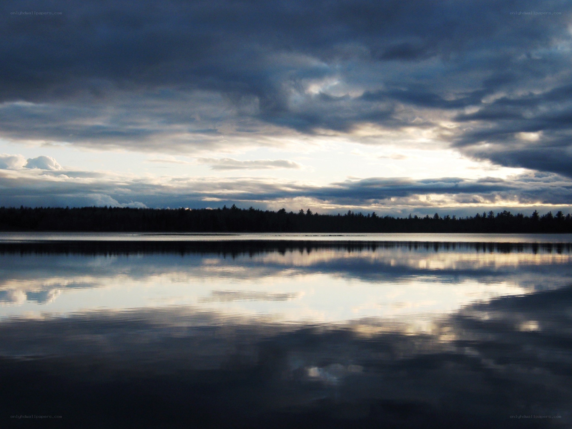 Lake at dusk with cloudy sky
