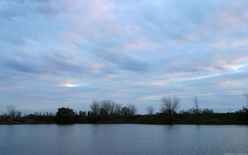 Lake at dusk with cloudy sky