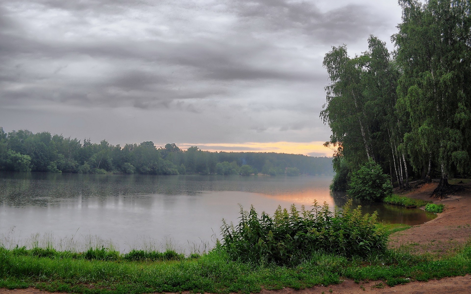 Lake at dusk with cloudy sky