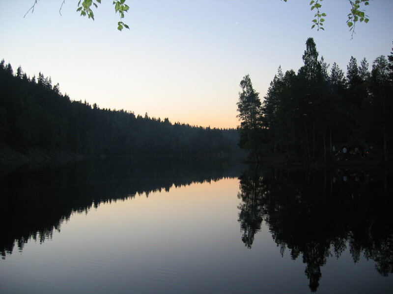 Lake at dusk with forest reflection