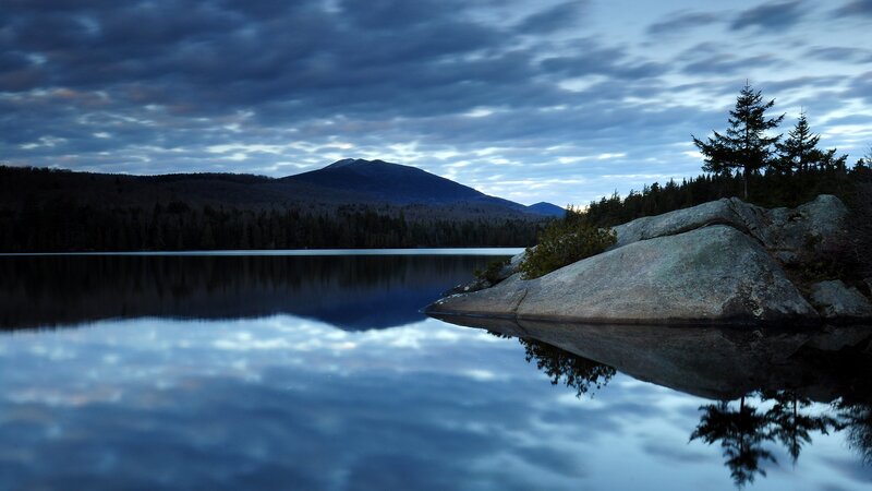 Lake at dusk with mountain reflection
