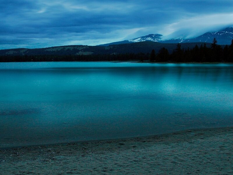 Lake at dusk with mountain view
