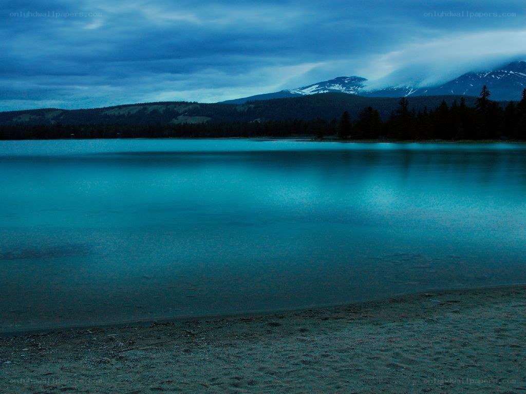 Lake at dusk with mountain view