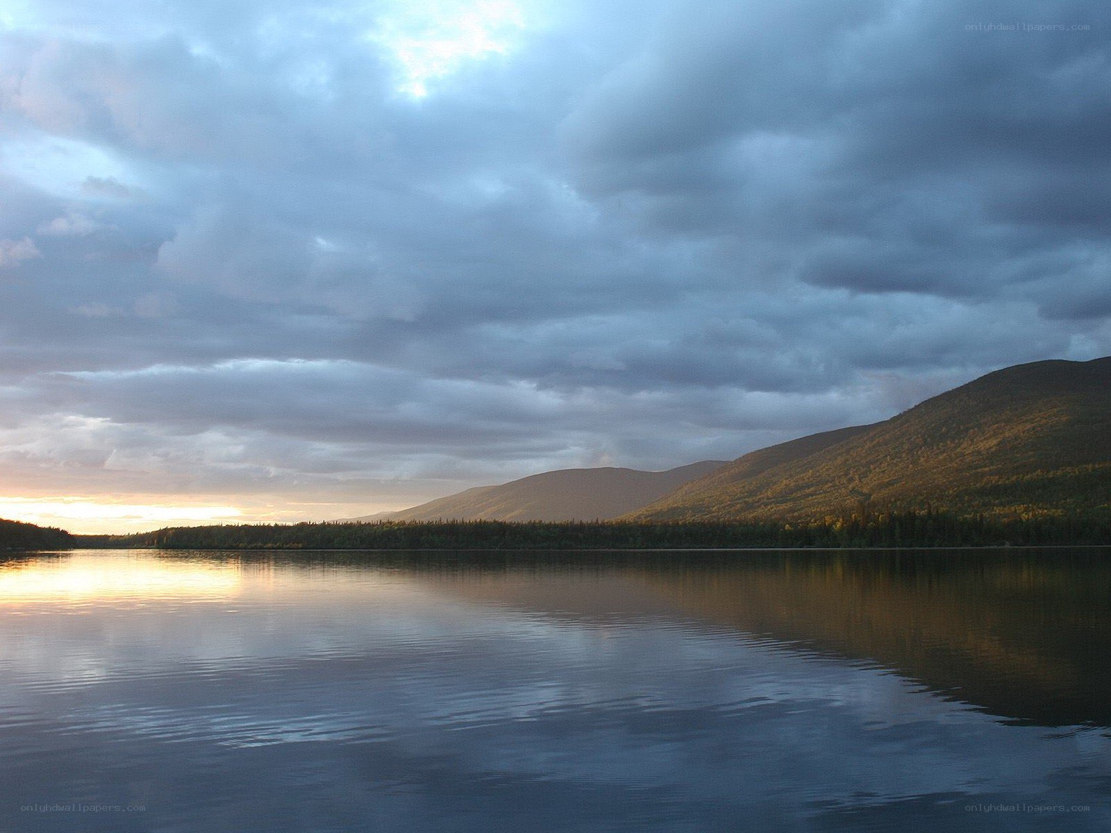 Lake at dusk with mountains
