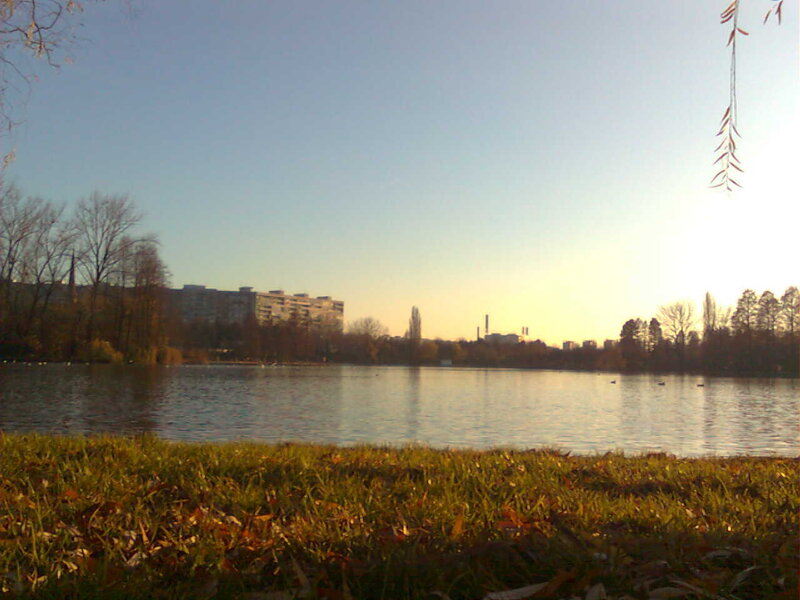 Lake at sunset with buildings