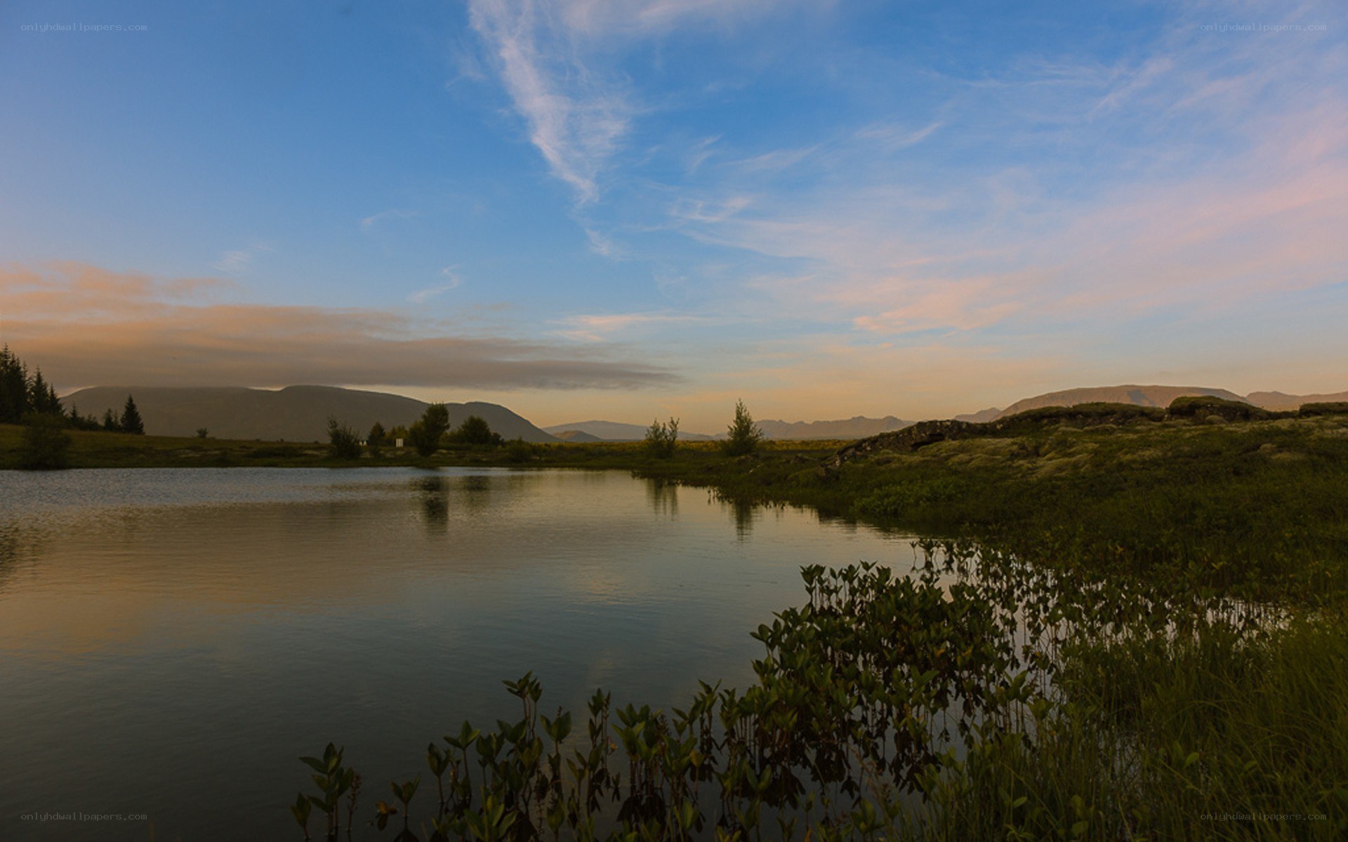 Lake at sunset with mountains