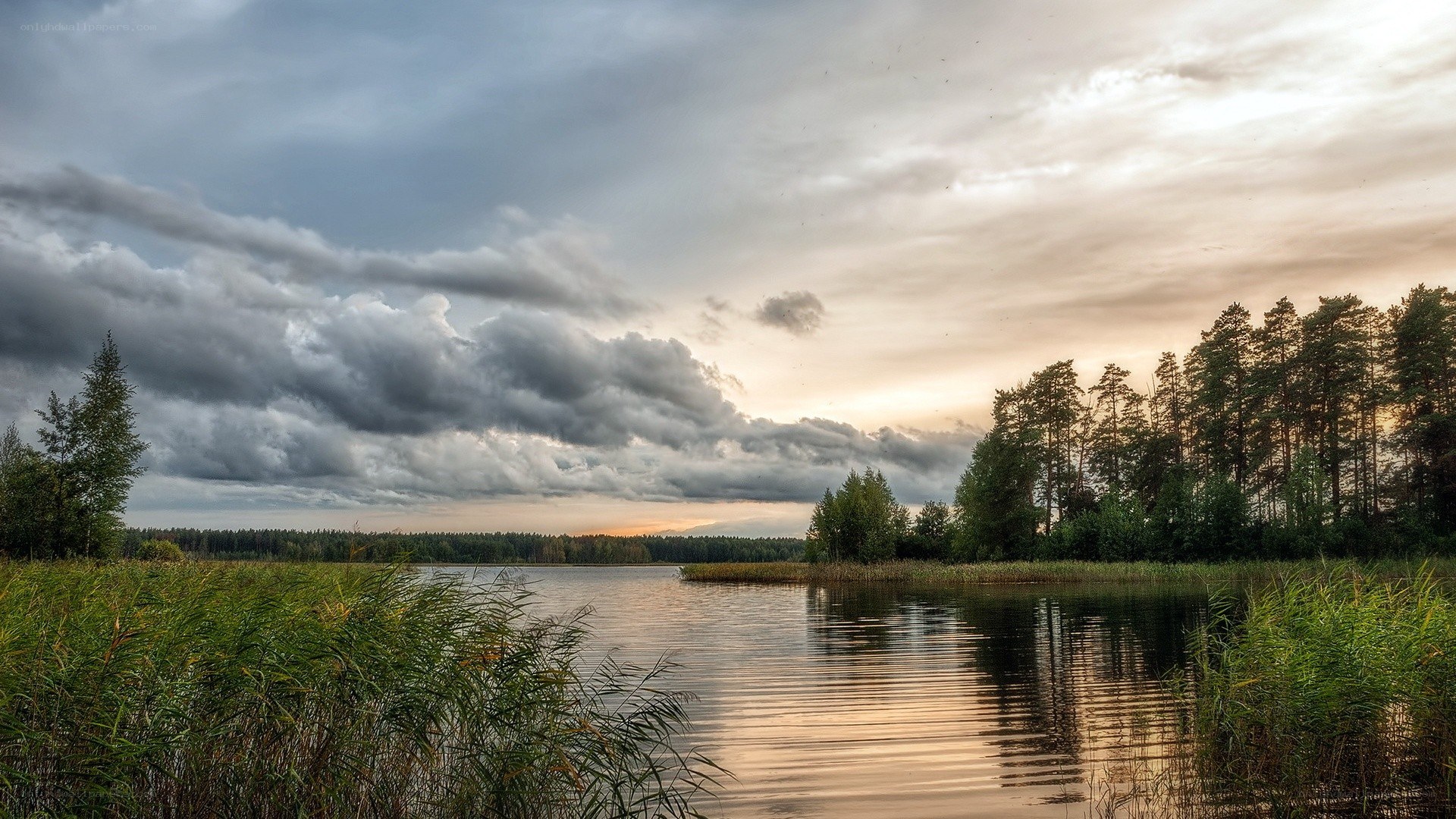 Lake at sunset with storm clouds
