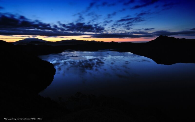 Lake at twilight with mountain silhouettes