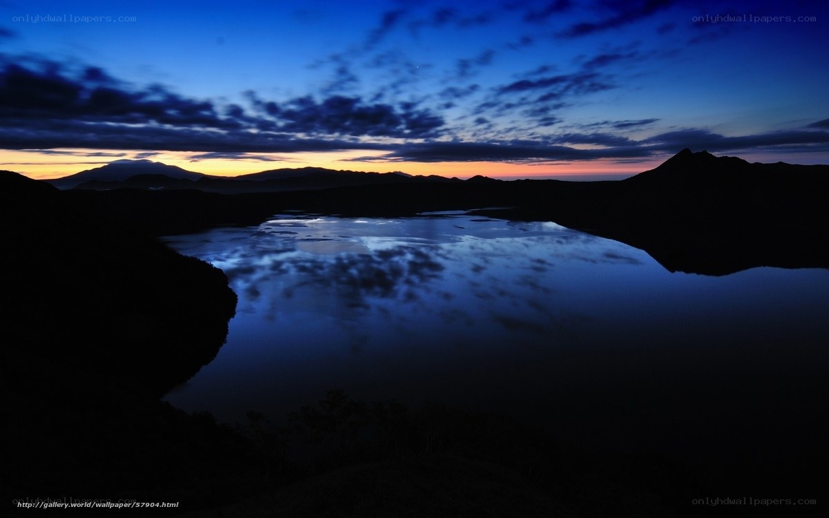 Lake at twilight with mountain silhouettes