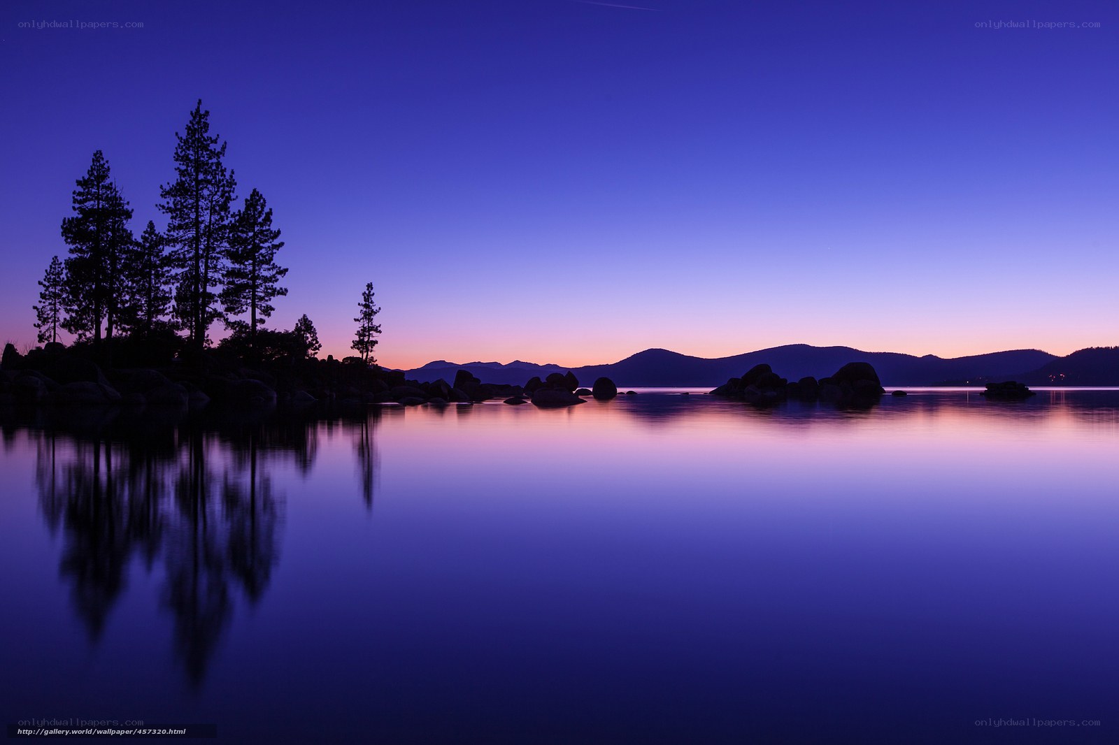 Lake at twilight with tree silhouettes