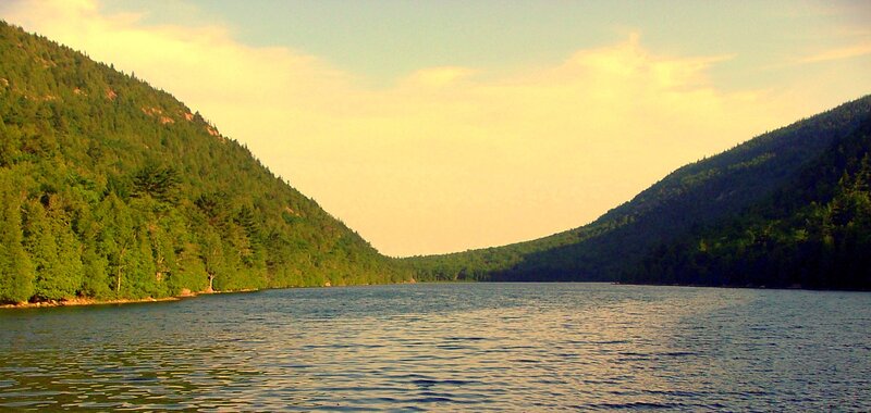 Lake between forested hills