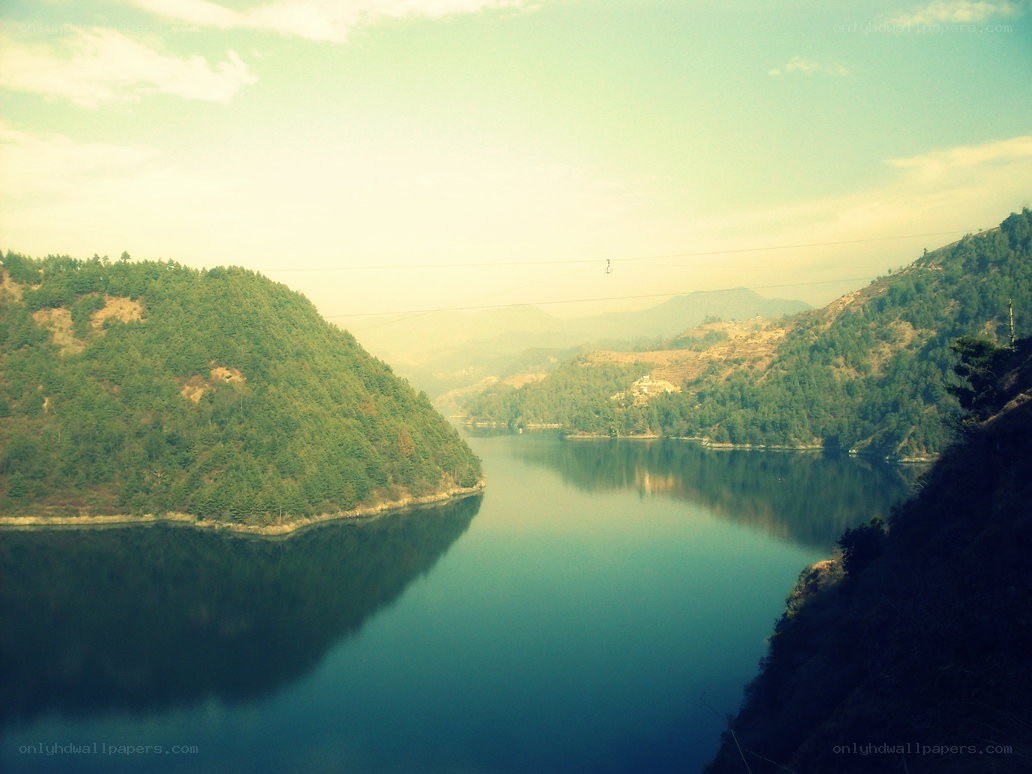 Lake between green hills