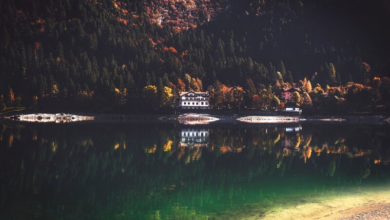 Lake house in autumn forest