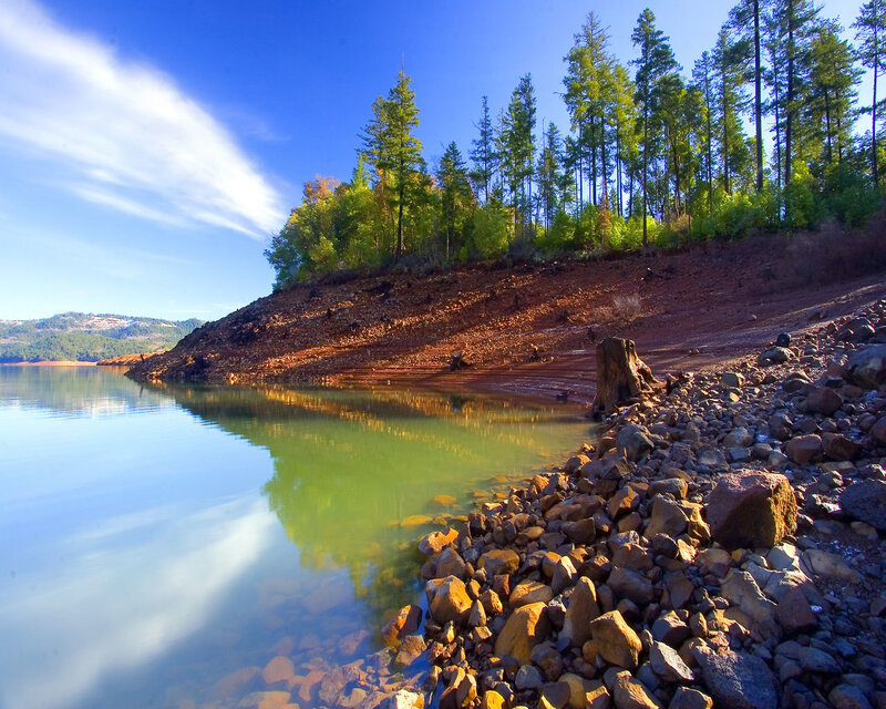 Lake shore with forested hill