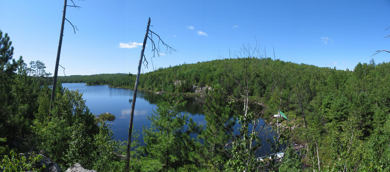 Lake Surrounded by Forest — Blue, Serene, Afternoon, Photograph, Trees, Sky, Rock