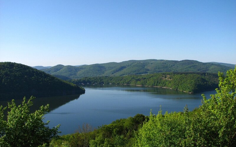 Lake surrounded by green hills