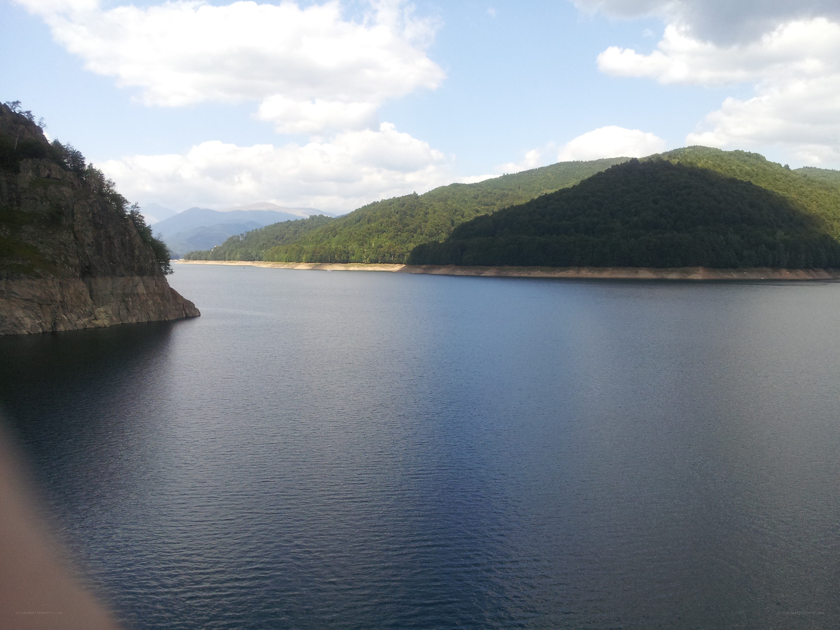 Lake surrounded by green hills