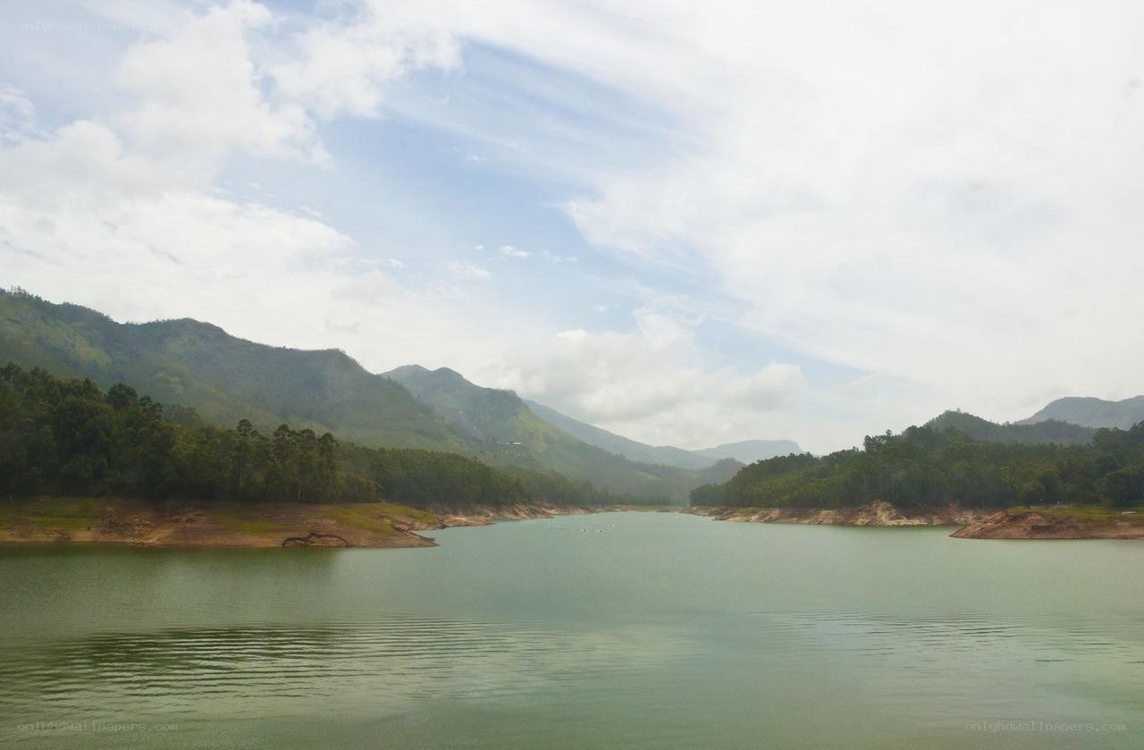 Lake surrounded by green hills