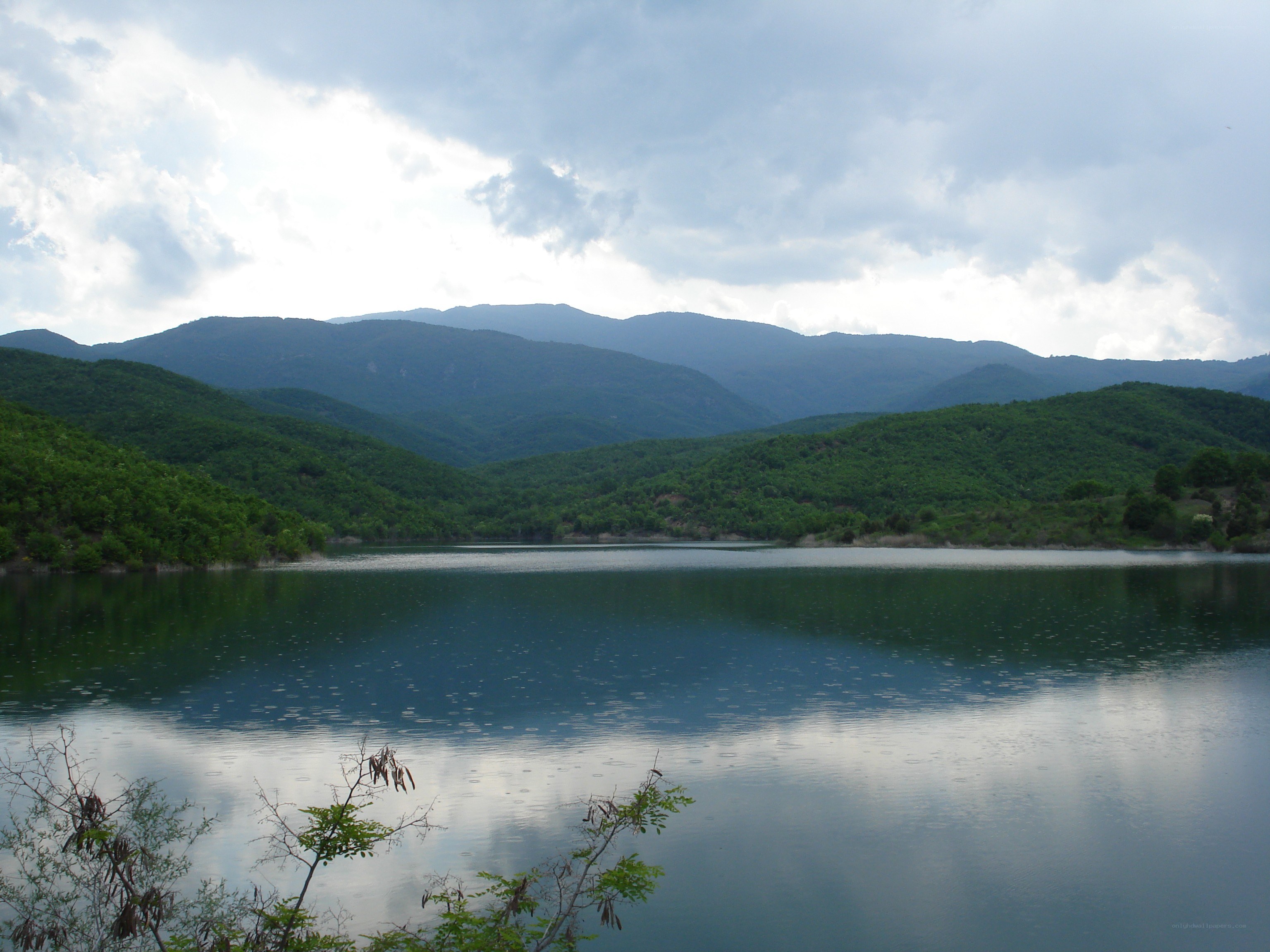 Lake surrounded by green hills