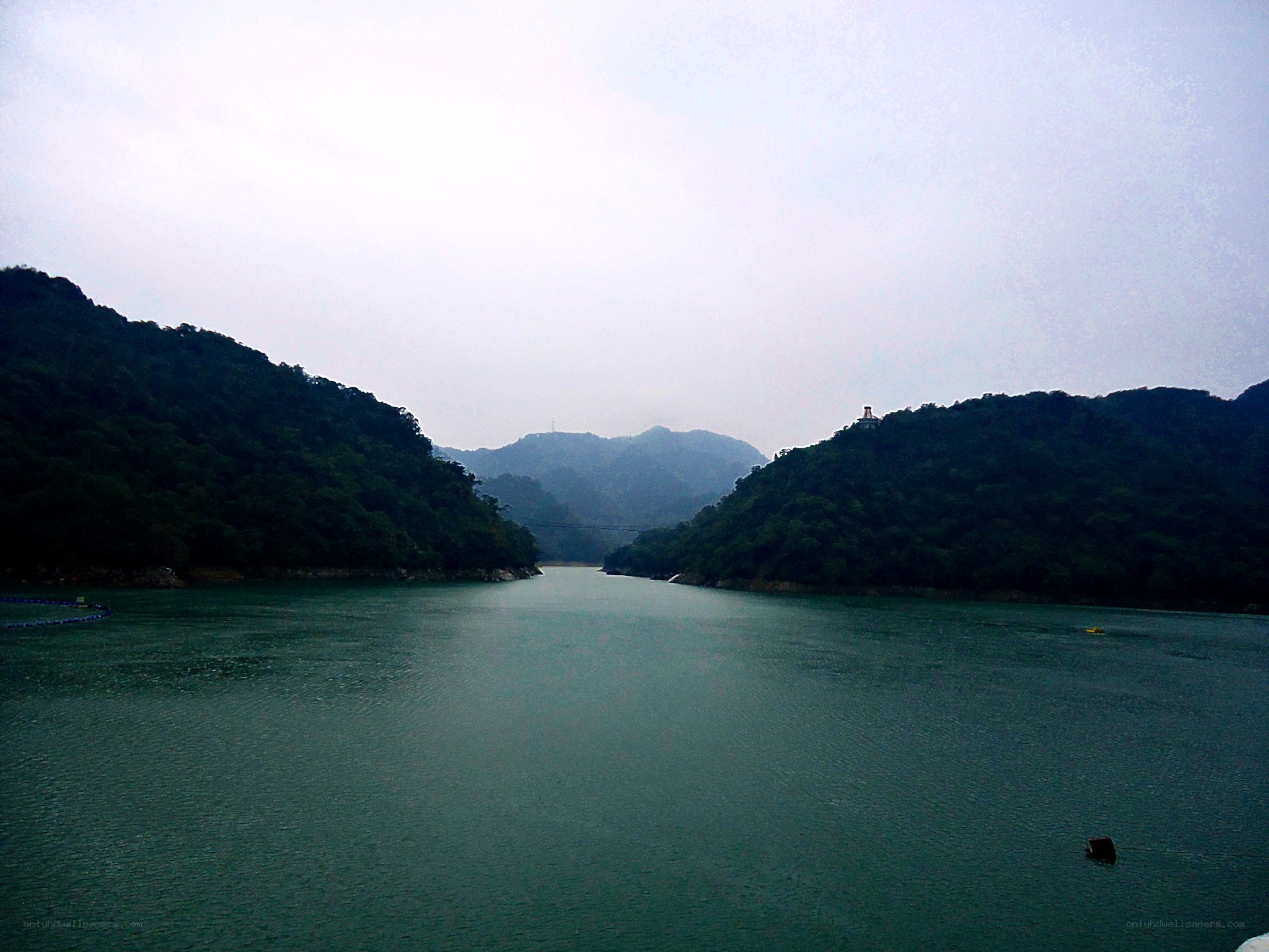 Lake surrounded by green hills