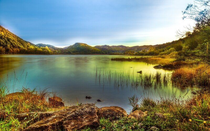 Lake Surrounded by Hills — Blue, Serene, Sunset, Photograph, Reeds