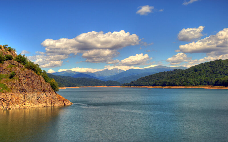 Lake Surrounded by Mountains — Blue, Serene, Afternoon, Photograph, Clouds, Boat
