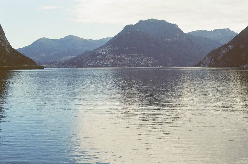 Lake Surrounded by Mountains — Blue, Serene, Afternoon, Photograph, Town