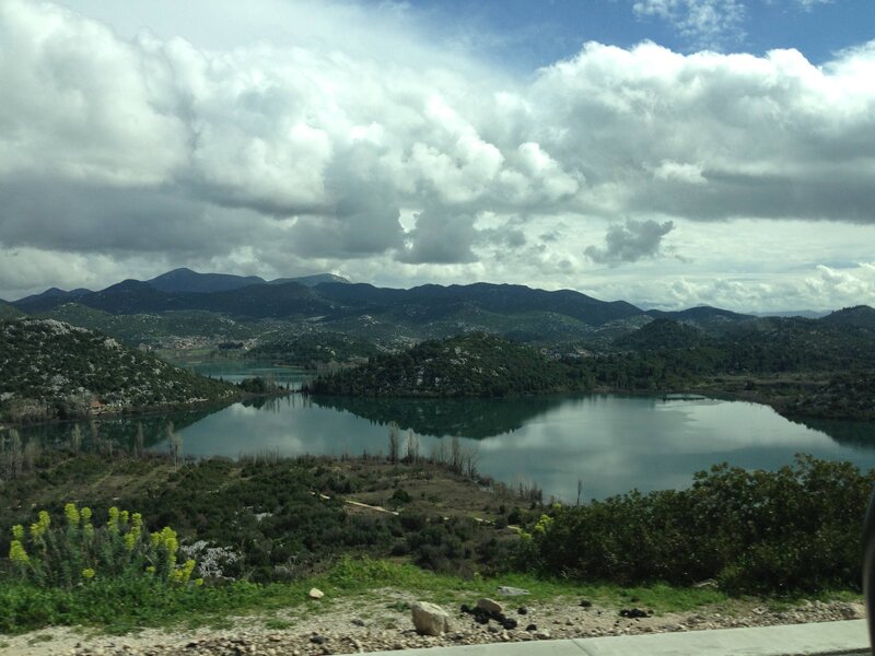 Lake Surrounded by Mountains — Green, Serene, Afternoon, Photograph, Trees, Clouds