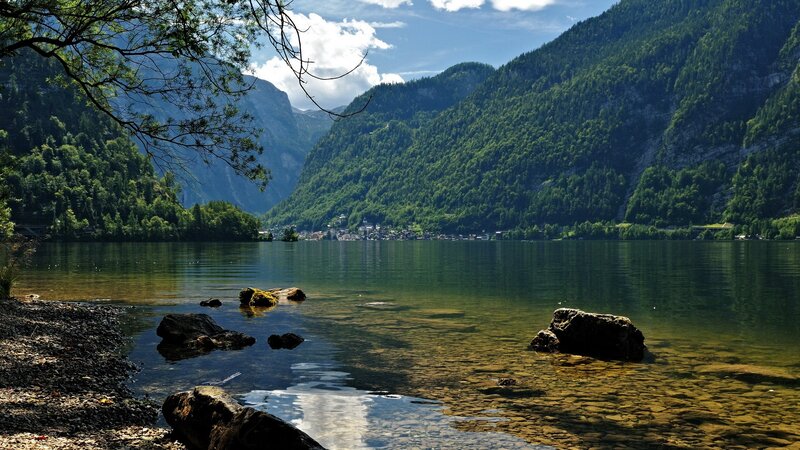 Lake Surrounded by Mountains — Green, Serene, Afternoon, Photograph, Trees, Rocks, Village