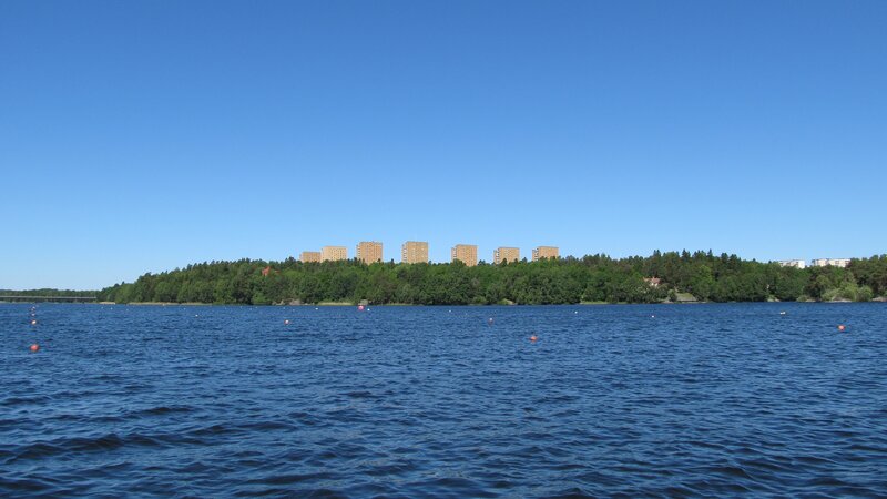 Lake with apartment buildings in background