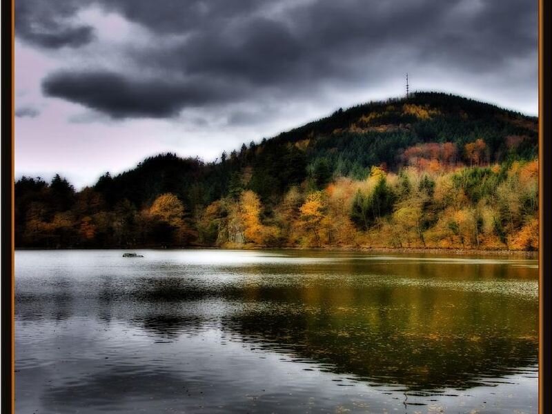 Lake with autumn forest and hill