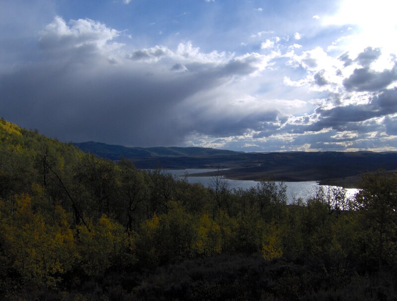 Lake with autumn trees and stormy sky