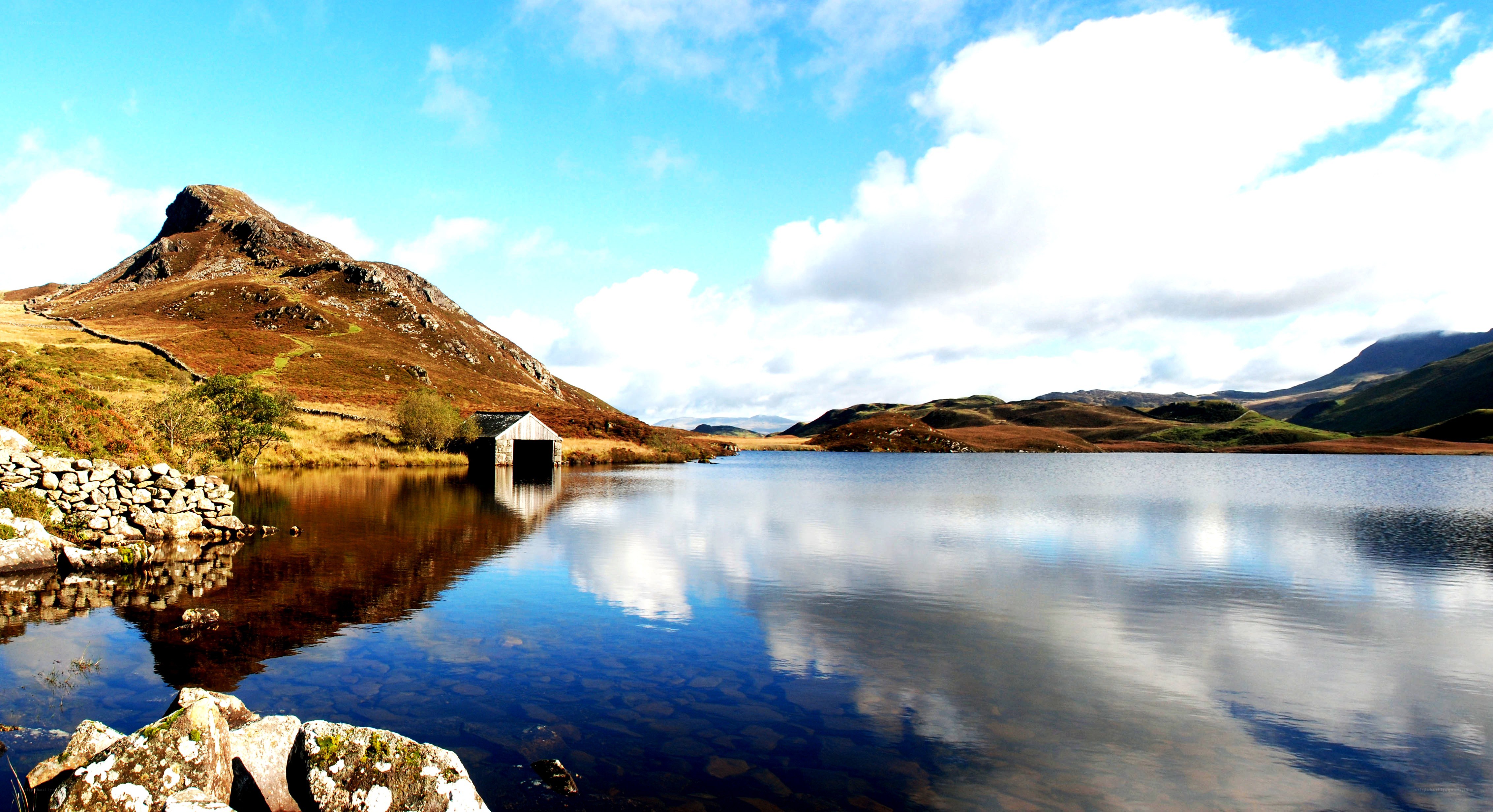 Lake with boathouse and mountain