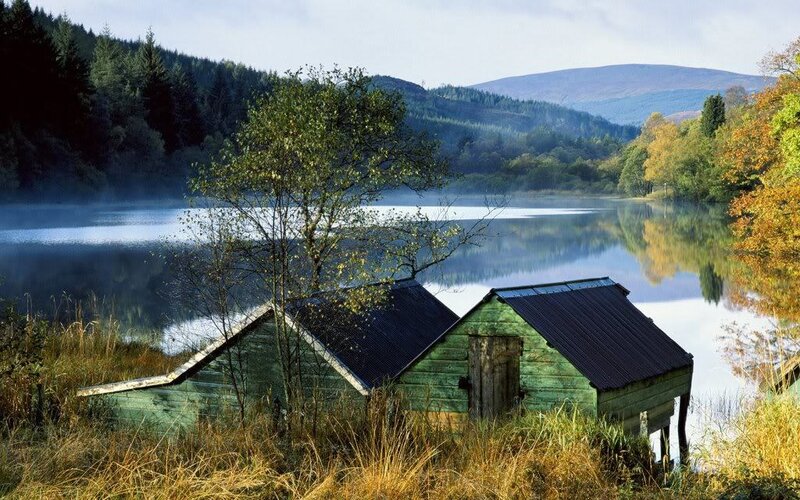 Lake with boathouses and mist