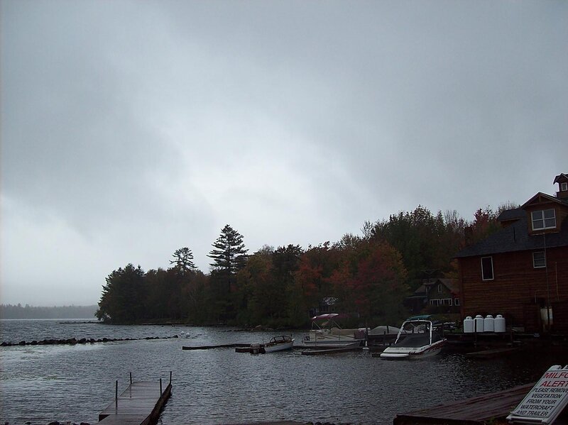Lake with Boats and Cabins