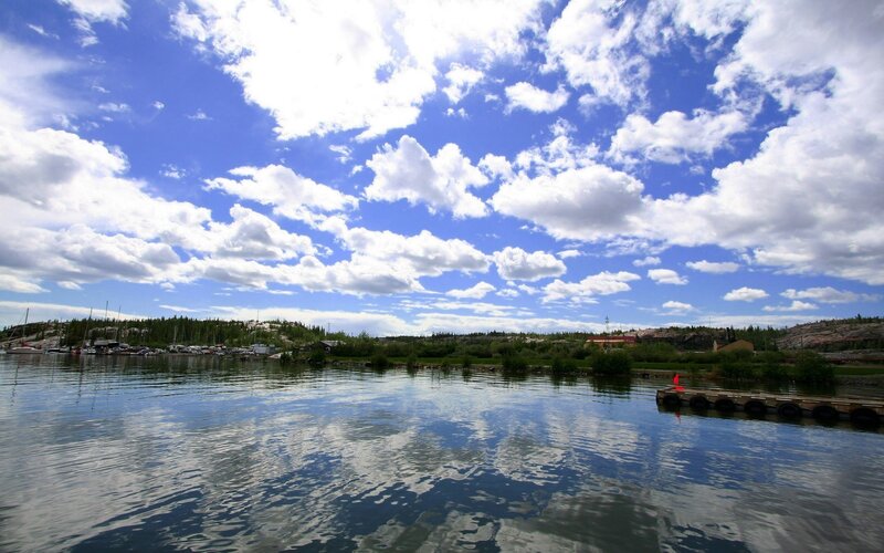 Lake with boats and clouds