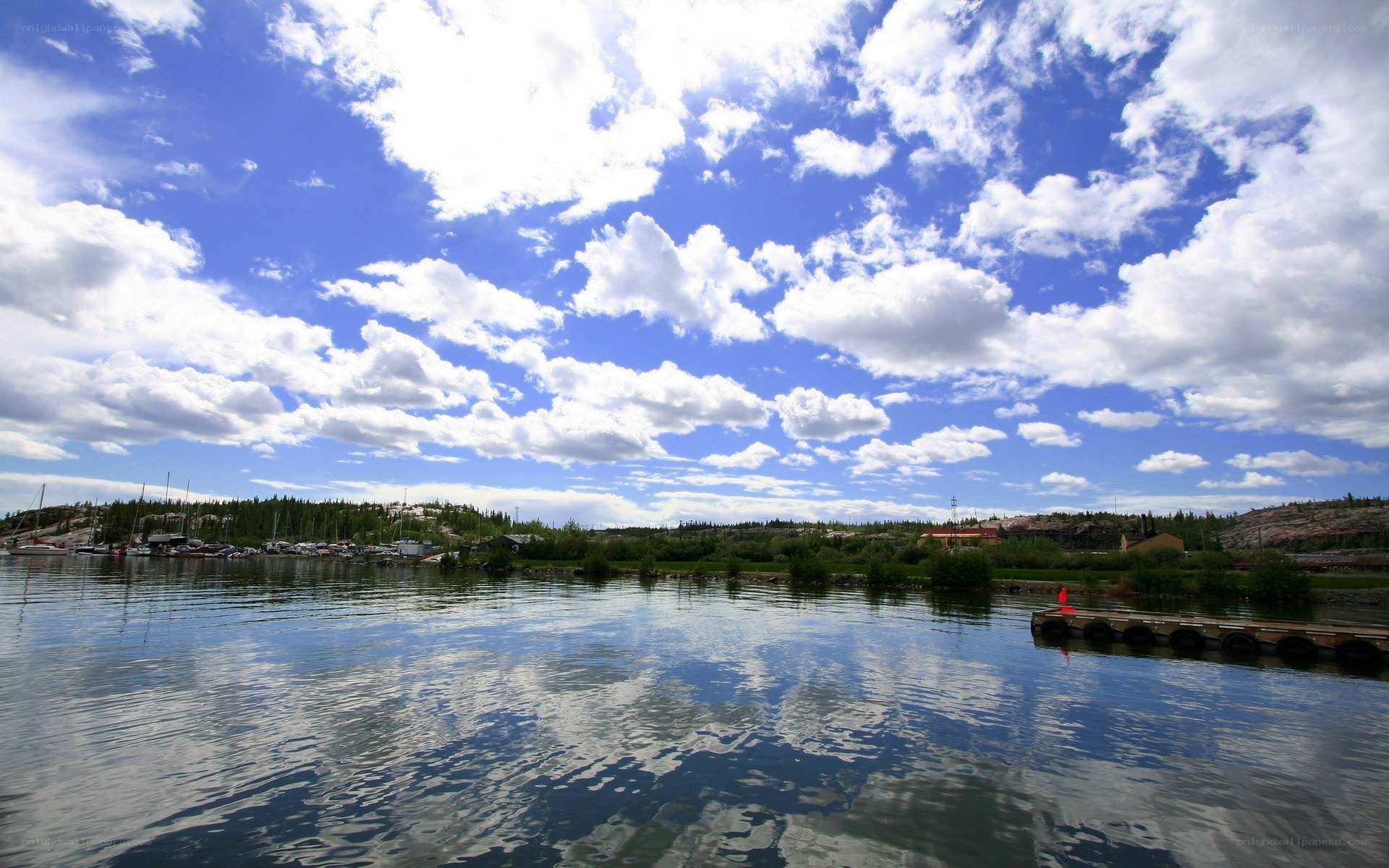 Lake with boats and clouds