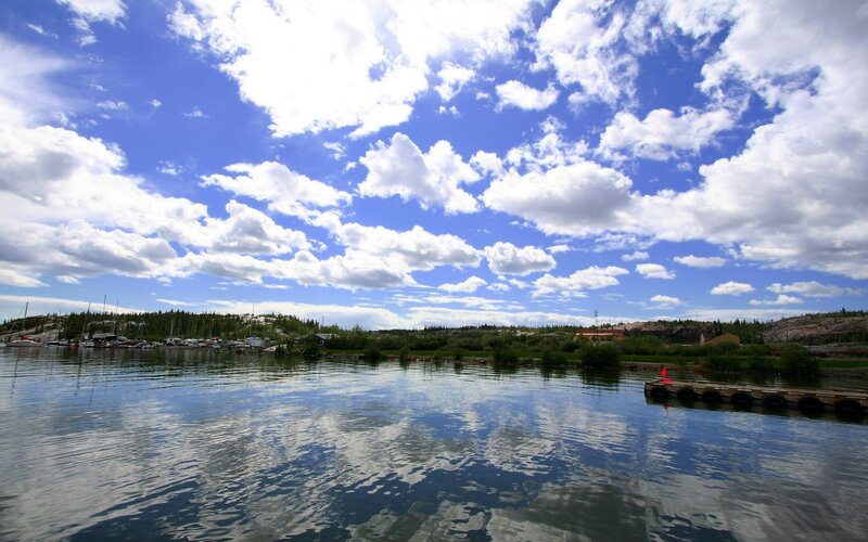 Lake with boats and clouds