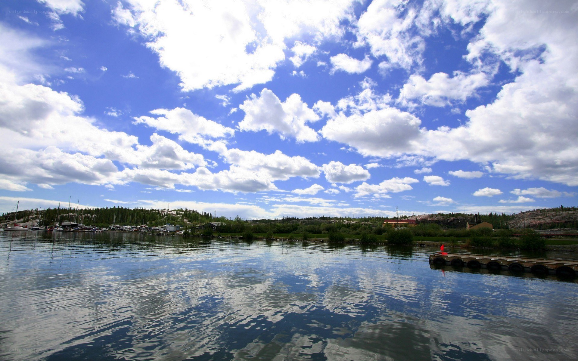 Lake with boats and clouds